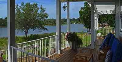 400+LaRua+Landing-2nd+floor+side+porch_03.jpg:  porch, railings, oak tree, Bayou Texar, trellis, deck, 