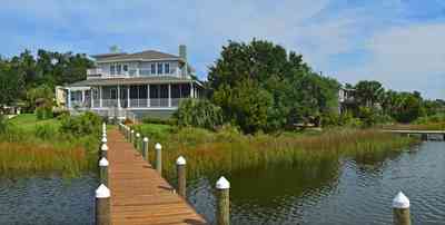 400+LaRua+Landing-rear+facade+facing+Bayou+Texar_03.jpg:  coastal home, pier, sawgrass, needle grass, deck Bayou Texar, 