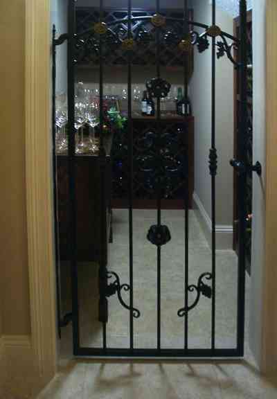 Aragon:-591-Aragon-Street_22.jpg:  wine cellar, wrought iron gate, dining room