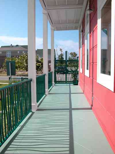 Aragon:-649-Aragon-Street_03.jpg:  charleston side-yard house, porch, wrought-iron railing, aragon development