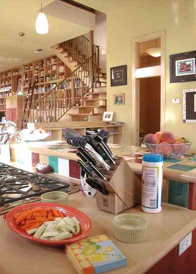 Aragon:-649-Aragon-Street_18.jpg:  vegetable tray, fiestaware, gas range, knife block, ceramic tile counter, open-tread staircase, bookcase, library