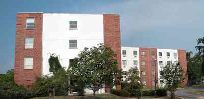 Belmont-Devillers:-The-Magnolias_08.jpg:  magnolia tree, fir tree, columns, brick building, nursing home, apartment building, 