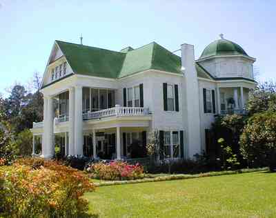 Brewton:-Belleville-Avenue_02.jpg:  victorian mansion, front porch, greek revival facade, classical revival, columns, azalea bushes, turret, colonnade