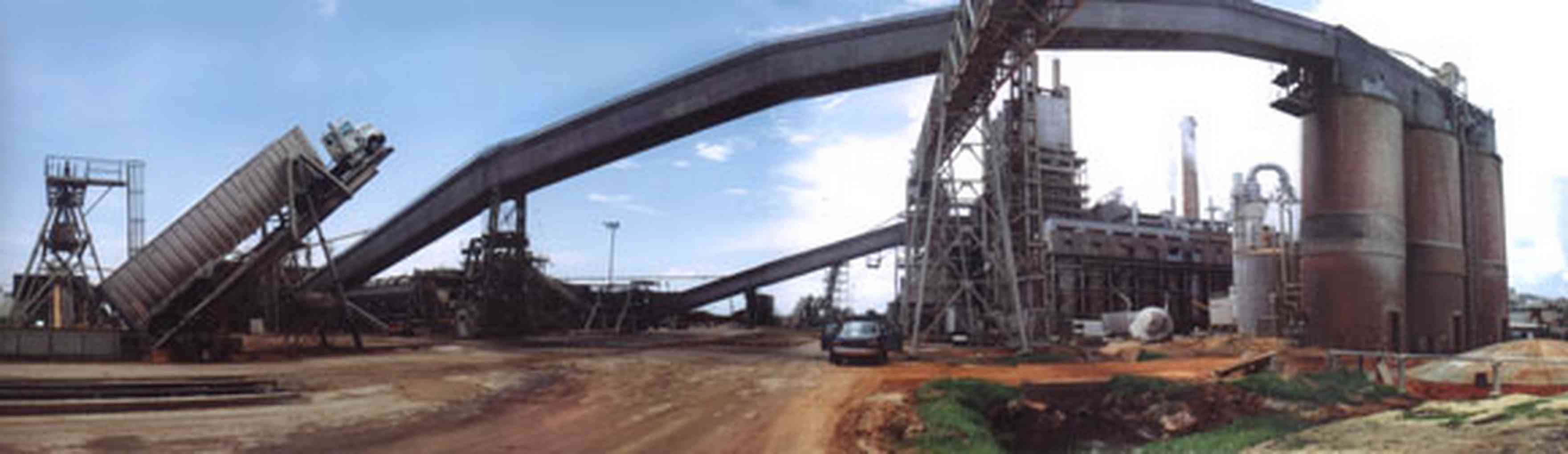 Brewton:-Jefferson-Smurfit-Company_0.jpg:  unloading, 18 wheeler, pulpwood plant, steam tower, dirt road, brewton, al