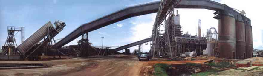 Brewton:-Jefferson-Smurfit-Company_0.jpg:  unloading, 18 wheeler, pulpwood plant, steam tower, dirt road, brewton, al