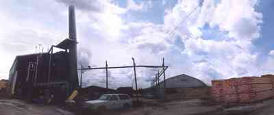 Brewton:-T.R.-Miller-Lumber-Company_7.jpg:  steam engine, stack of lumber, lumber mill