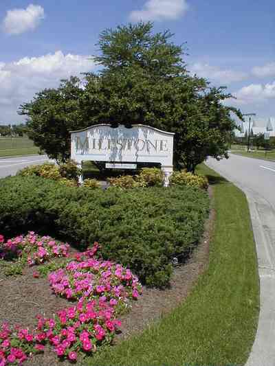 Cantonment:-Milestone_01.jpg:  sign, development, subdivision, petunia, median