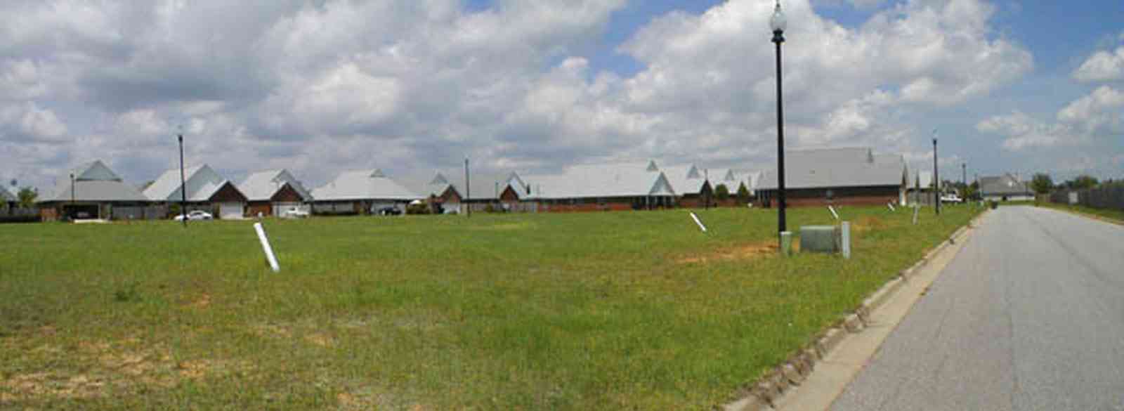 Cantonment:-Milestone_15.jpg:  cumulus clouds, oak trees, boulevard, tract houses, garden