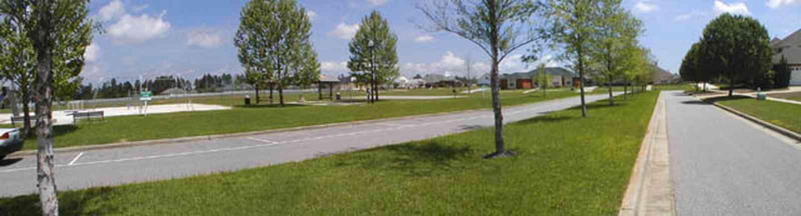 Cantonment:-Milestone_16.jpg:  cumulus clouds, oak trees, boulevard, tract houses, garden