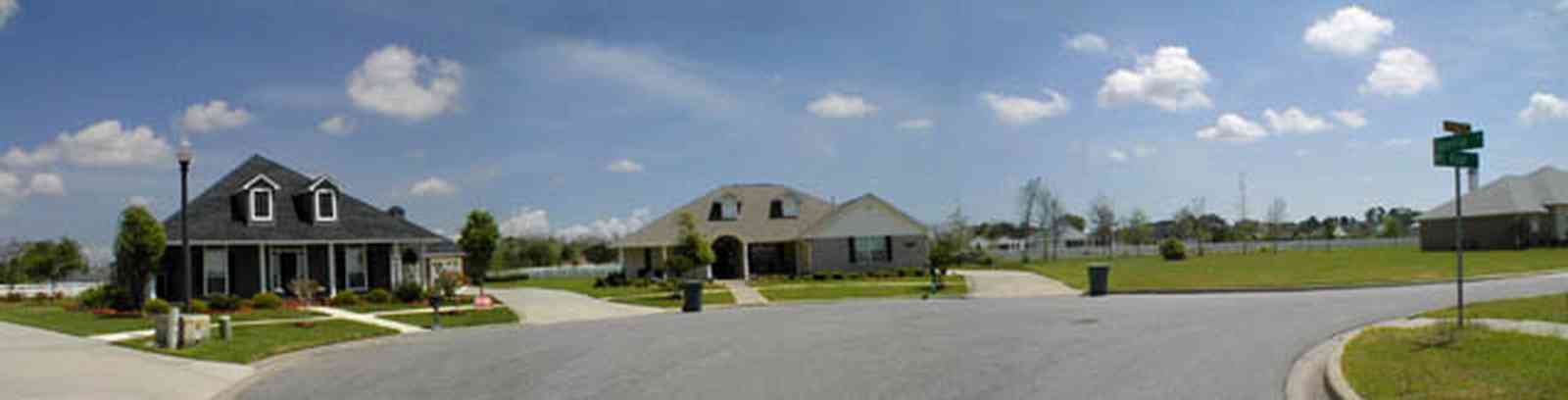 Cantonment:-Milestone_17.jpg:  cumulus clouds, oak trees, boulevard, tract houses,  garden