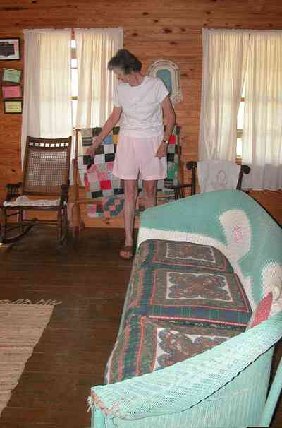 Cantonment:-Roy-Hyatt-Environmental-Center-Dog-Trot-House_16.jpg Cantonment:-Roy-Hyatt-Environmental-Center-Dog-Trot-House_16.jpg: iron bed, quilt, ragdoll, bedroom, wooden walls, wood floor, rocking chair