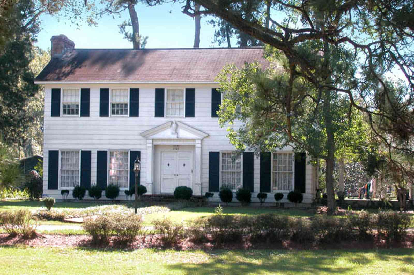 Century:-7542-South-Jefferson-Avenue_02.jpg:  colonial house, classical pediment, pine tree, shutters, historic district, azalea bush