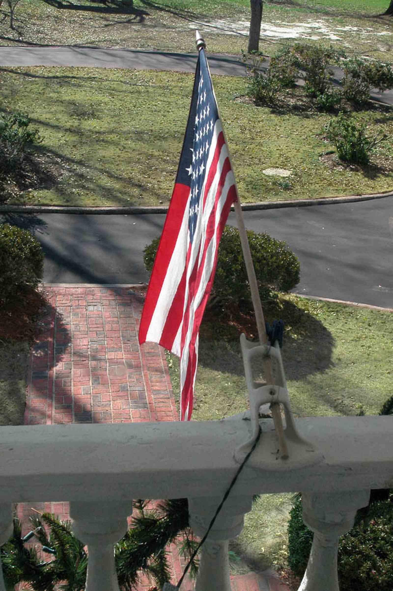 Century:-Tannenheim_01w.jpg:  balcony, american flag, balustrade, brick sidewalk, driveway, mansion, plantation home