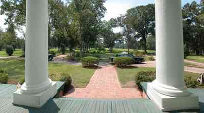 Century:-Tannenheim_01x.jpg Century:-Tannenheim_01x.jpg: pecan tree, porch, columns, azelea bush