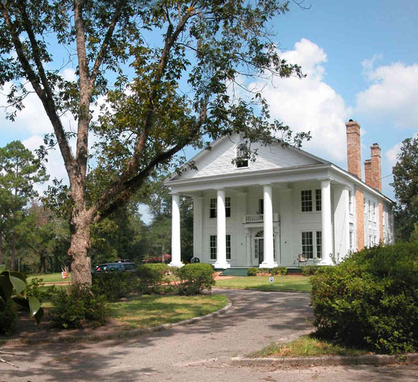 Century:-Tannenheim_02b.jpg:  victorian mansion, southern mansion, white columns, heart pine wood, tongue and groove walls, pasture, lake pecan orchard, plantation, rolling pastures, timber, hedge, azalea bush, country road