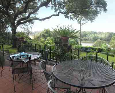 East-Hill:-1801-East-La-Rua-Street_06.jpg:  patio, wrought-iron tables, wrought-iron chairs, ferns, terrezzo tiles