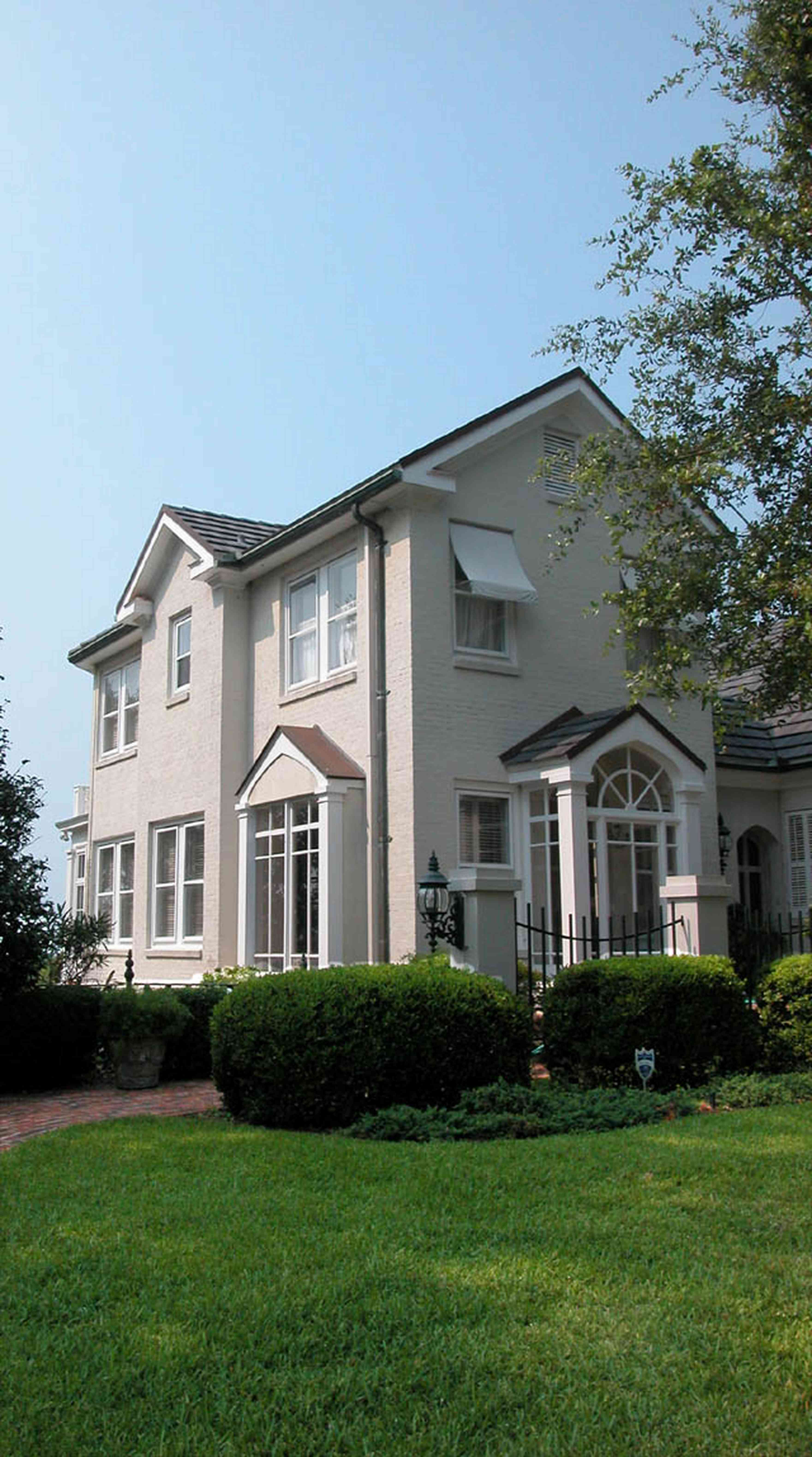 East-Hill:-1823-East-La-Rua-Street_02.jpg:  brick driveway, box hedges, slate roof, garden, stucco house, 