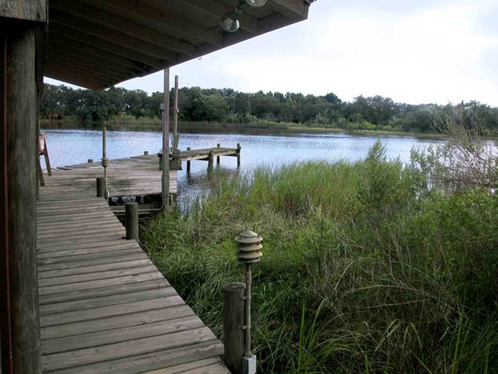 East-Hill:-1919-East-La-Rua-Street_07.jpg:  deck, bench, bayou, swamp, sawgrass, bayou texar, cumulus clouds, fishing pier, 