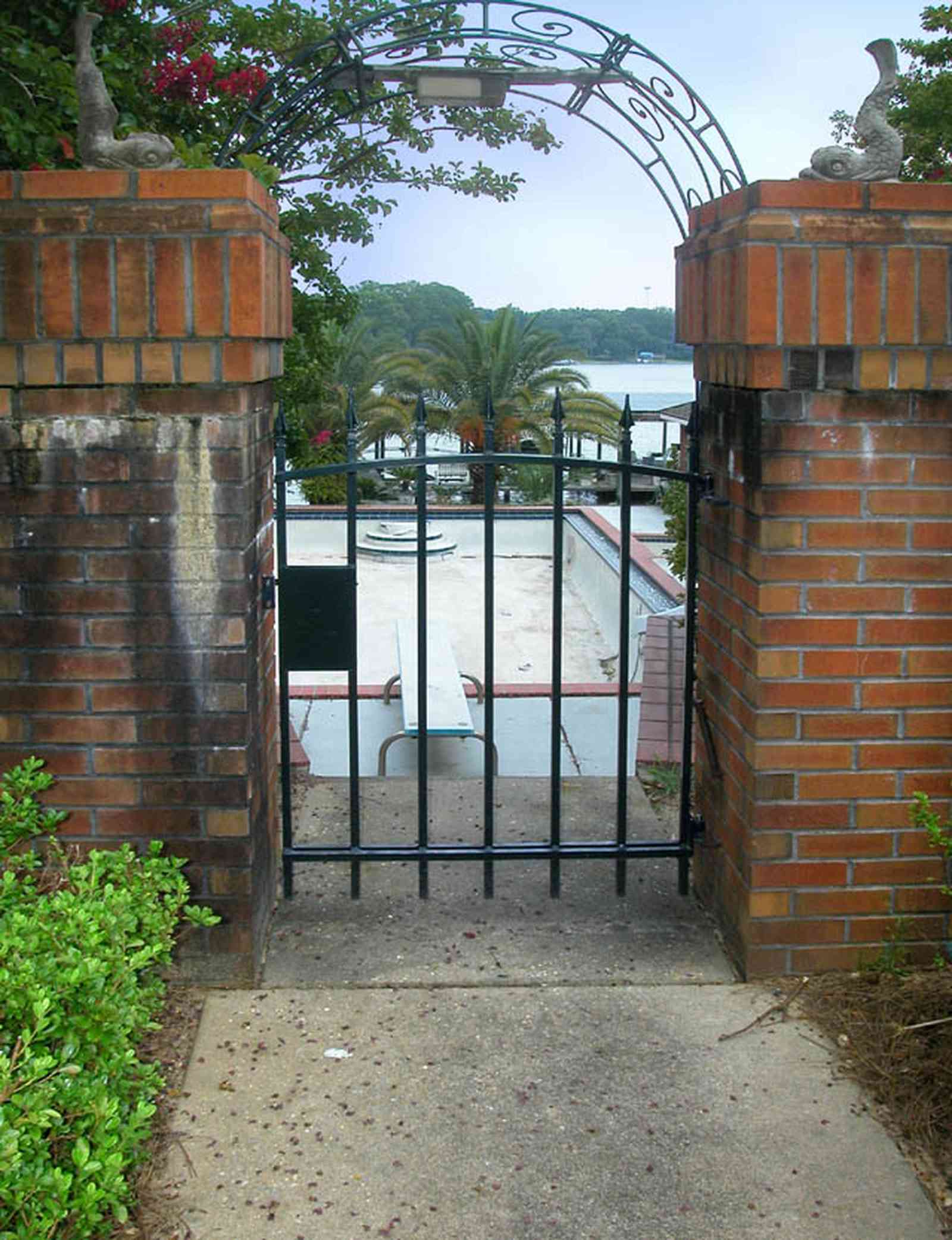 East-Hill:-2000-Whaley-Avenue_06.jpg:  red brick house, impatiens, box hedges, oak trees, columns, shutters, bayou, garden gate, 