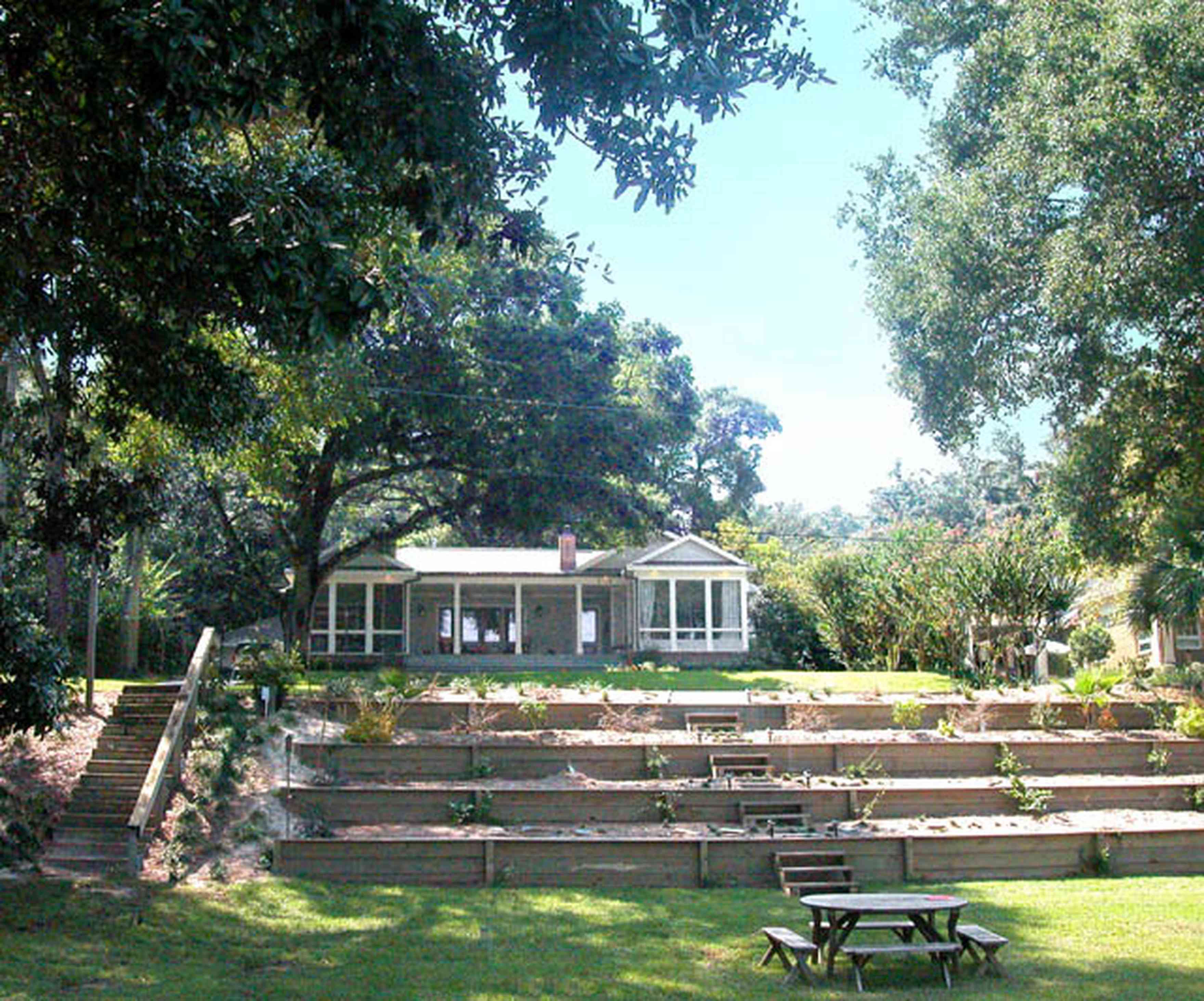 East-Hill:-2109-Whaley-Drive_01.jpg:  picnic table, ranch style home, front porch, oak trees, glassed-in porch