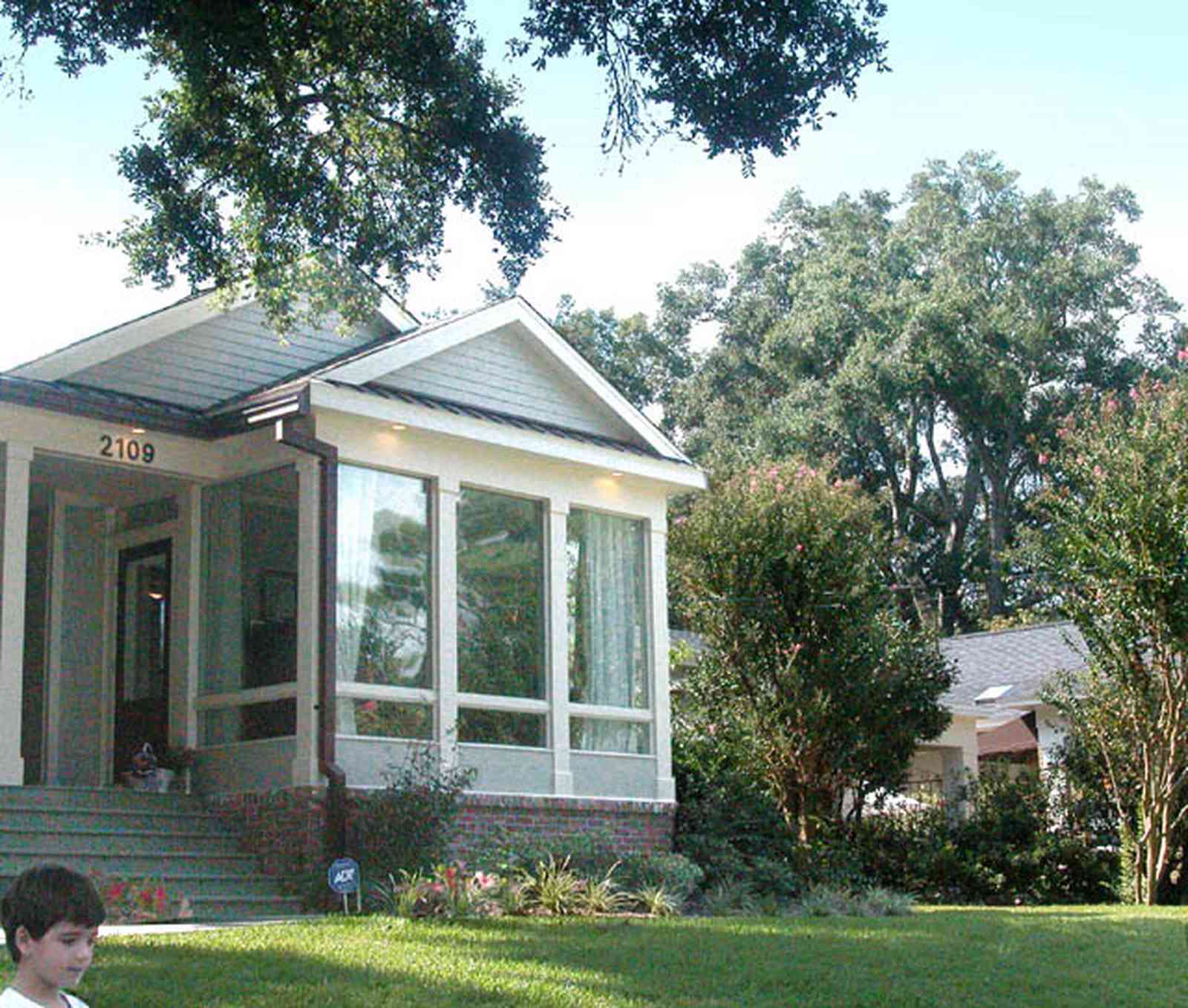 East-Hill:-2109-Whaley-Drive_04.jpg:  glassed-in porch, front steps, lawn, oak tree, ranch-style home, crepe myrtle tree