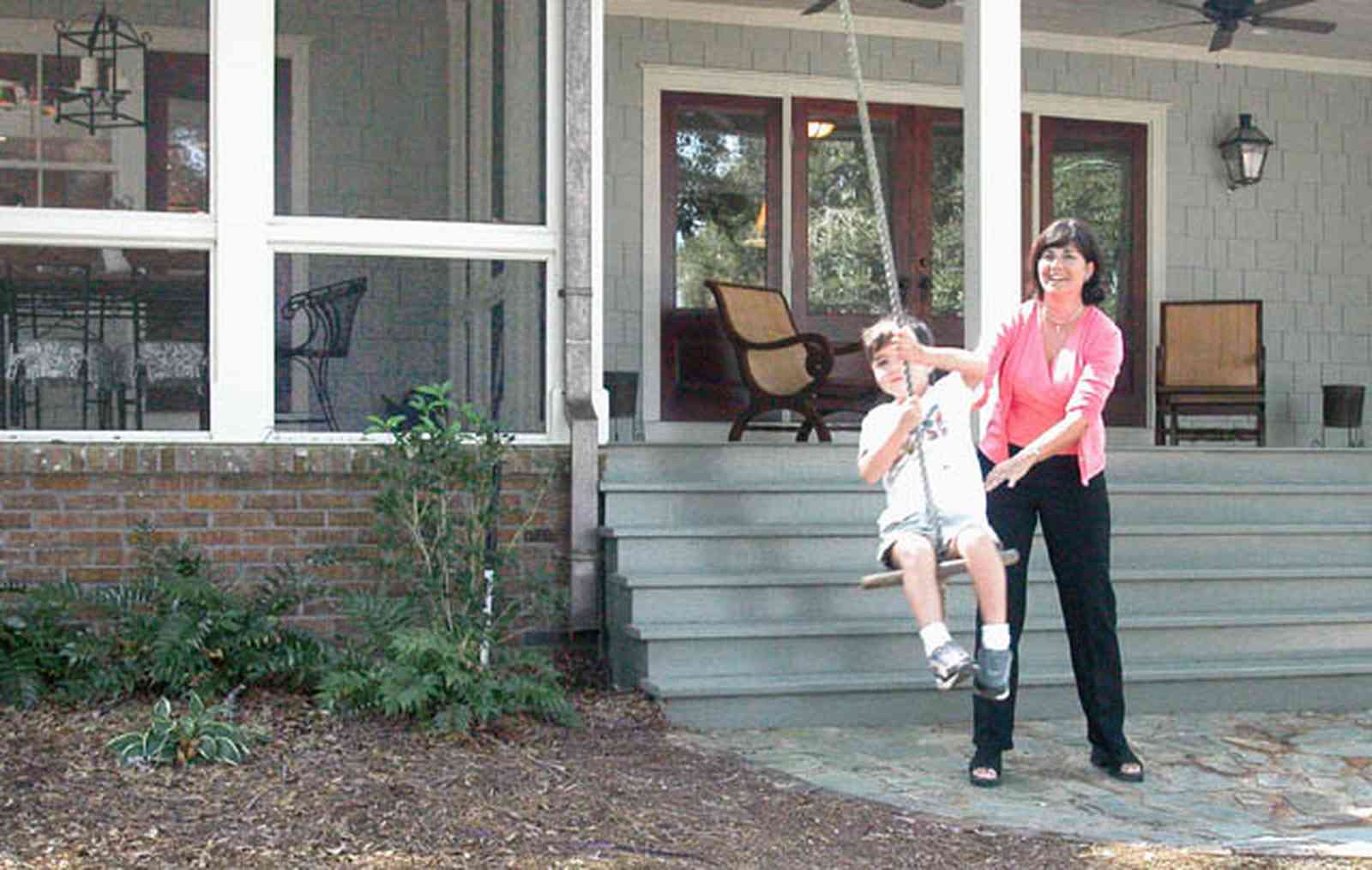 East-Hill:-2109-Whaley-Drive_11.jpg:  front porch, screen porch, ceiling fan, swing, stone patio