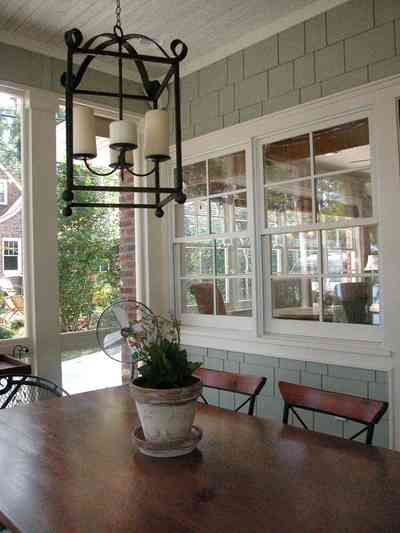 East-Hill:-2109-Whaley-Drive_15.jpg:  flower pot, dining table, shingles, wrought-iron lantern, candles, screen porch