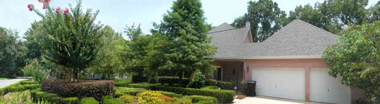 East-Hill:-617-19th-Avenue_08.jpg:  garage, fir tree, boxwood hedge, pink brick house