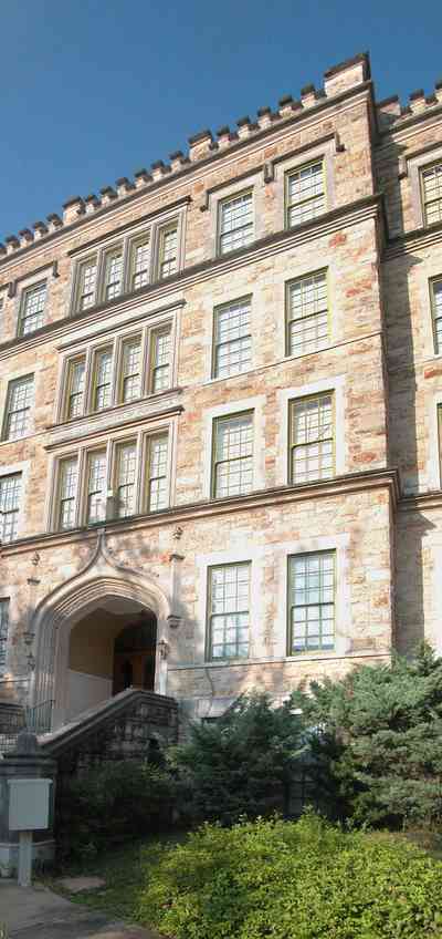 East-Hill:-Tower-East:-Old-Sacred-Heart-Hospital_03.jpg:  stone construction, romanesque architecture, fir tree, pointed arch, casement windows, stone courses, hospital