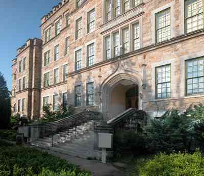 East-Hill:-Tower-East:-Old-Sacred-Heart-Hospital_05.jpg:  stone construction, romanesque architecture, fir tree, pointed arch, casement windows, stone courses, hospital