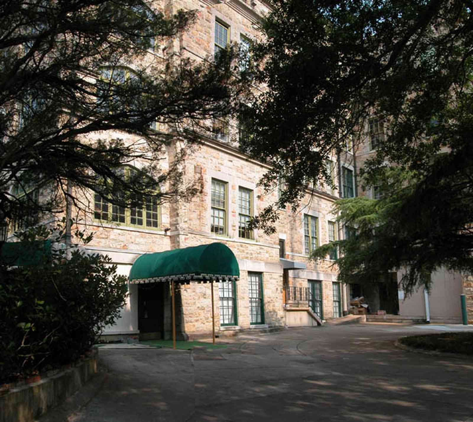 East-Hill:-Tower-East:-Old-Sacred-Heart-Hospital_21.jpg:  fir tree, stone battlements, entrance patio, hospital