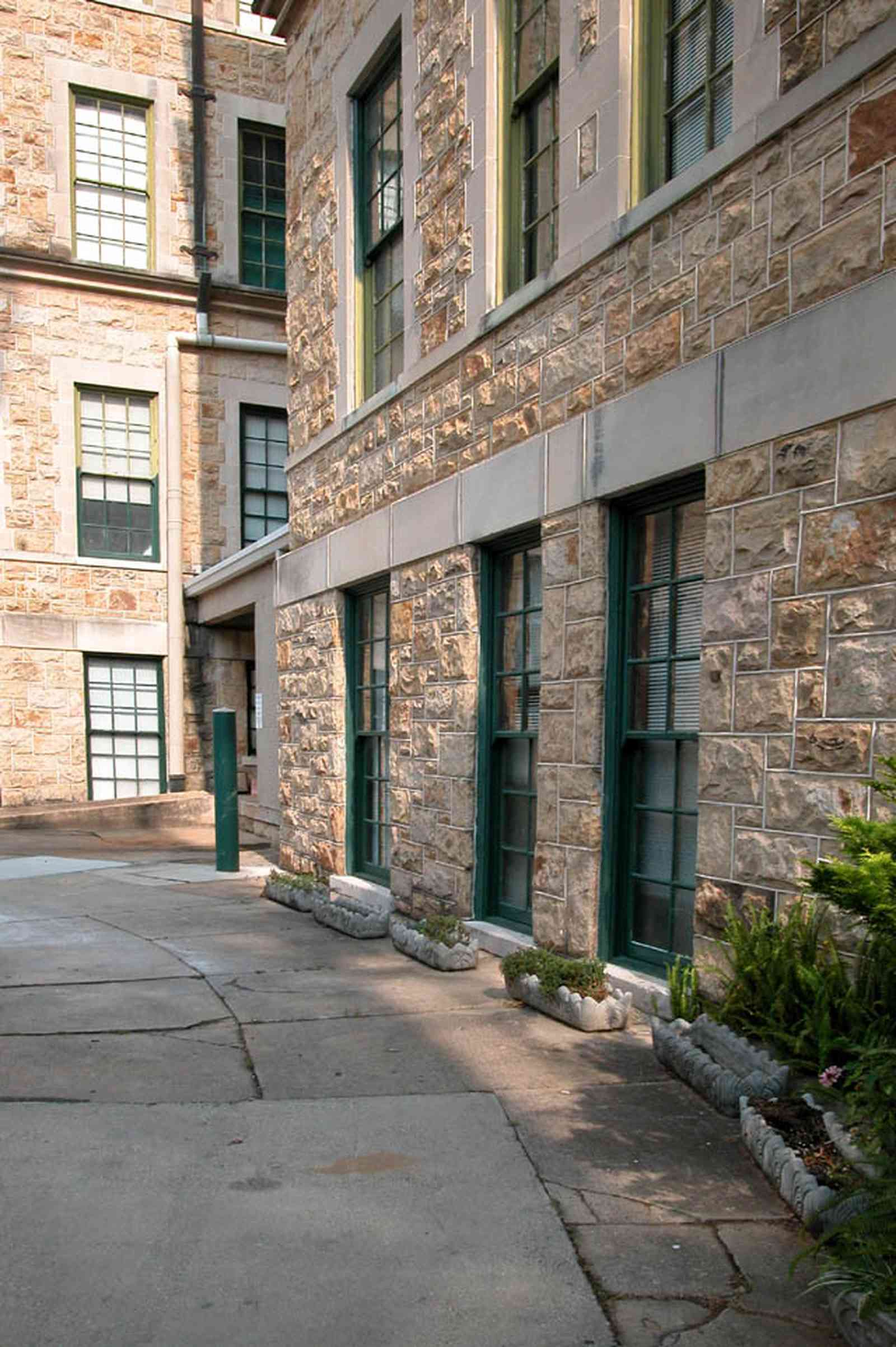 East-Hill:-Tower-East:-Old-Sacred-Heart-Hospital_22.jpg:  fir tree, stone battlements, entrance patio, hospital