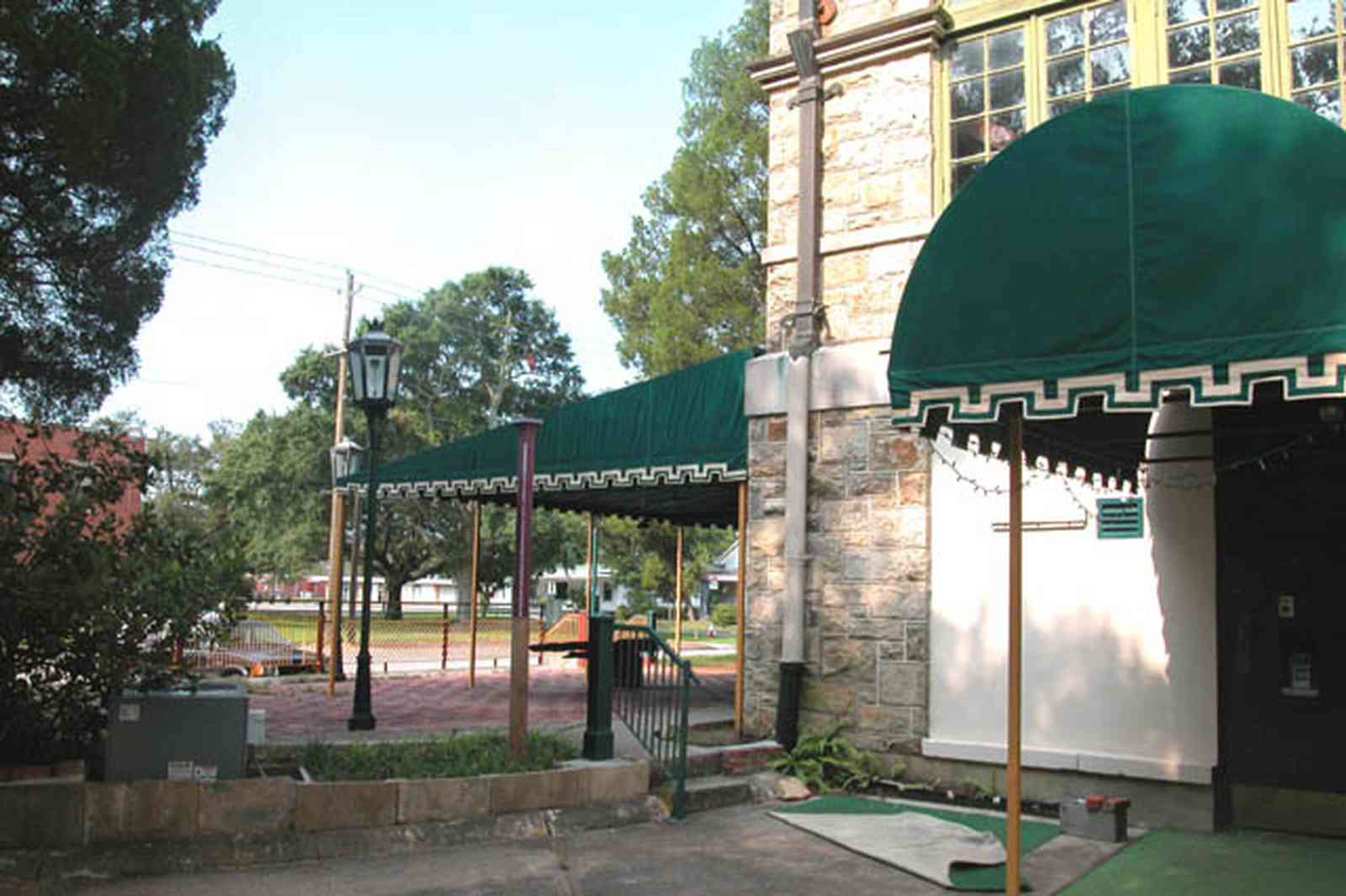 East-Hill:-Tower-East:-Old-Sacred-Heart-Hospital_23.jpg:  fir tree, stone battlements, entrance patio, hospital