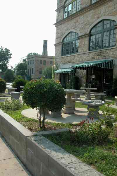 East-Hill:-Tower-East:-Old-Sacred-Heart-Hospital_35.jpg:  awning, casement windows, table and bench, hospital, restaurant, stone facade