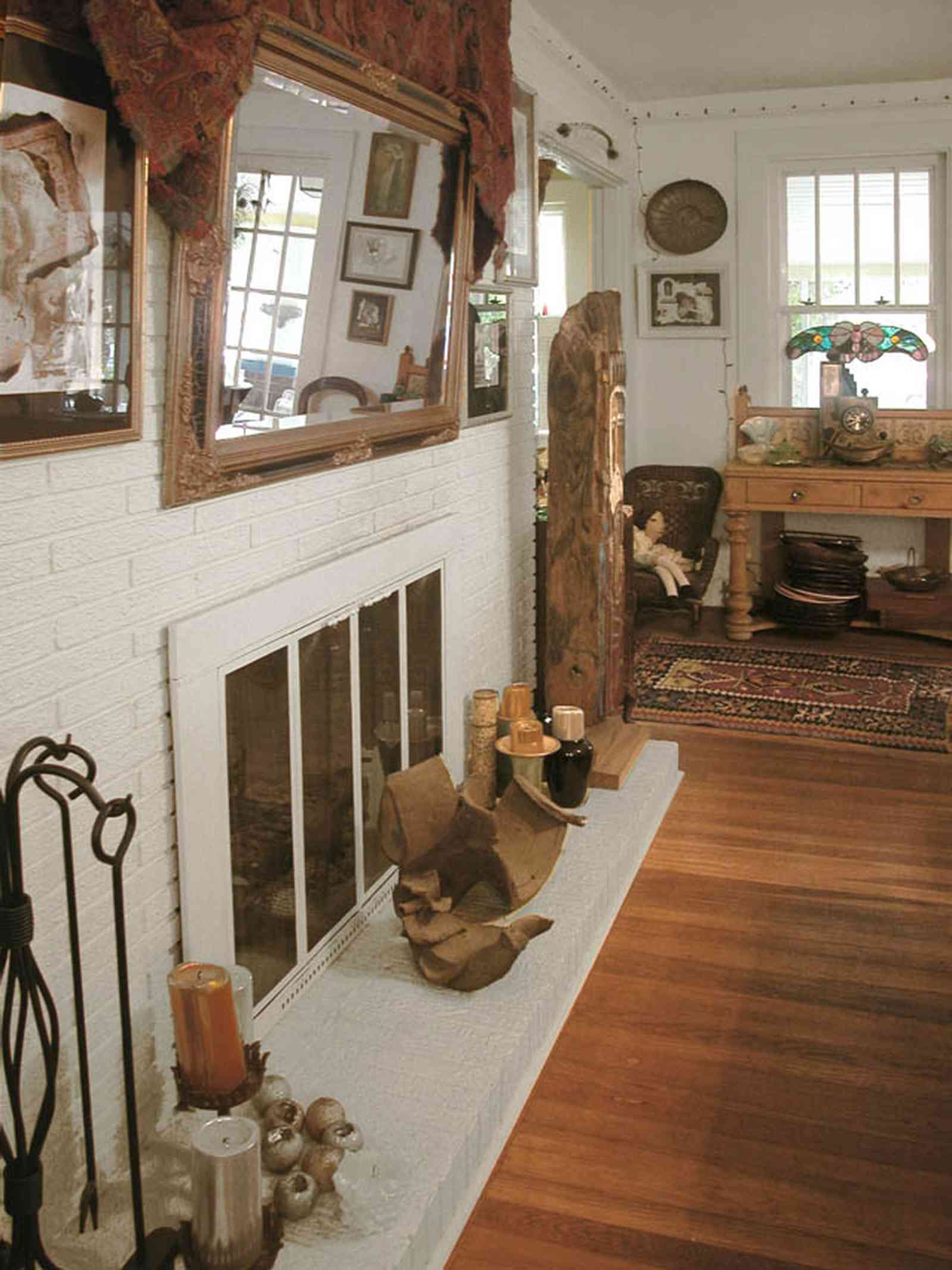 East-Pensacola-Heights:-600-Bayou-Blvd_09.jpg:  hearth, fireplace, heartpine floors, mirror, mantel, oriental rug, stucco walls