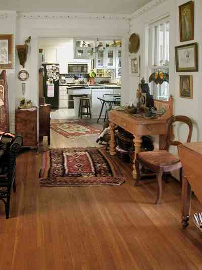 East-Pensacola-Heights:-600-Bayou-Blvd_10.jpg:  heart pine floors, oriental rug, desk, open floor plan, dining area, kitchen, stucco walls