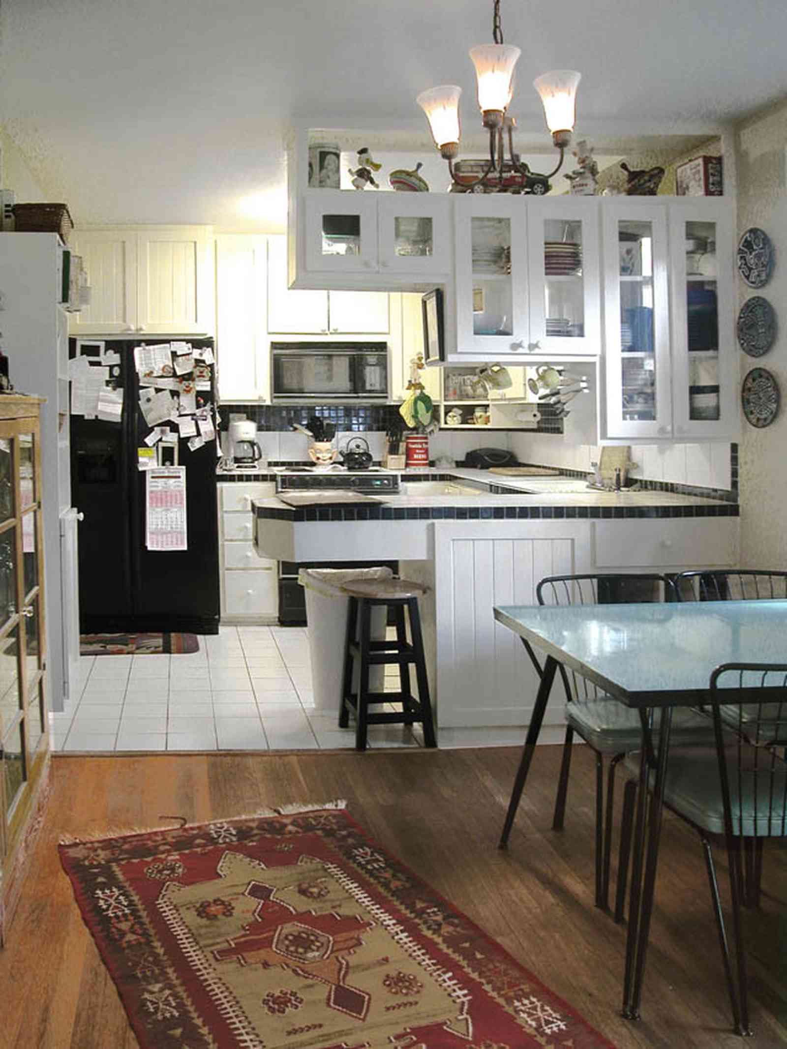 East-Pensacola-Heights:-600-Bayou-Blvd_11.jpg:  glass cabinets, heart pine floors, dining room table, kitchen stool, built-in appliances, white ceramic tile