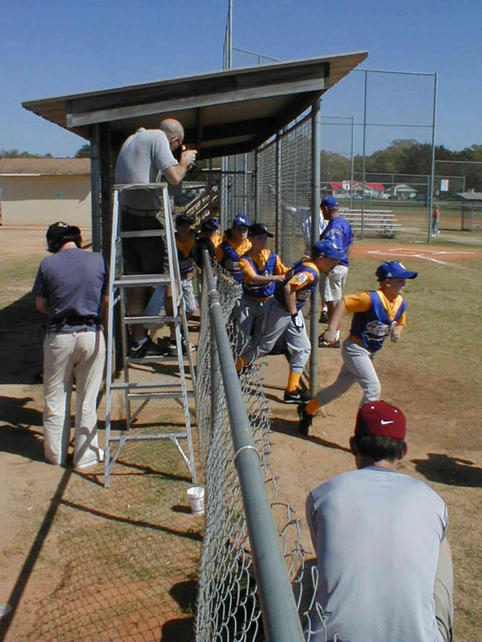 Ensley:-JR-Jones-Ballfield_08.jpg:  photographer, dugout, ball players, mike, little league players
