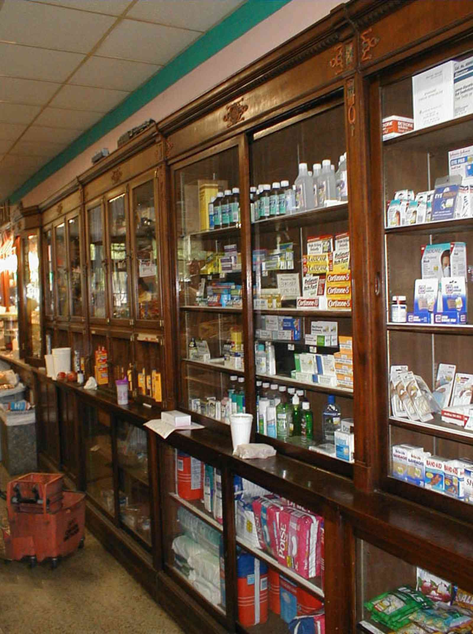 Foley:-Staceys-Drugstore_12.jpg:  drugstore, soda fountain, banana split, glass display cases, soda shop, awning, store front, brick building, art deco architecture, counter, cracker barrel, malts, milkshake, prescription drugs, druggist, card racks