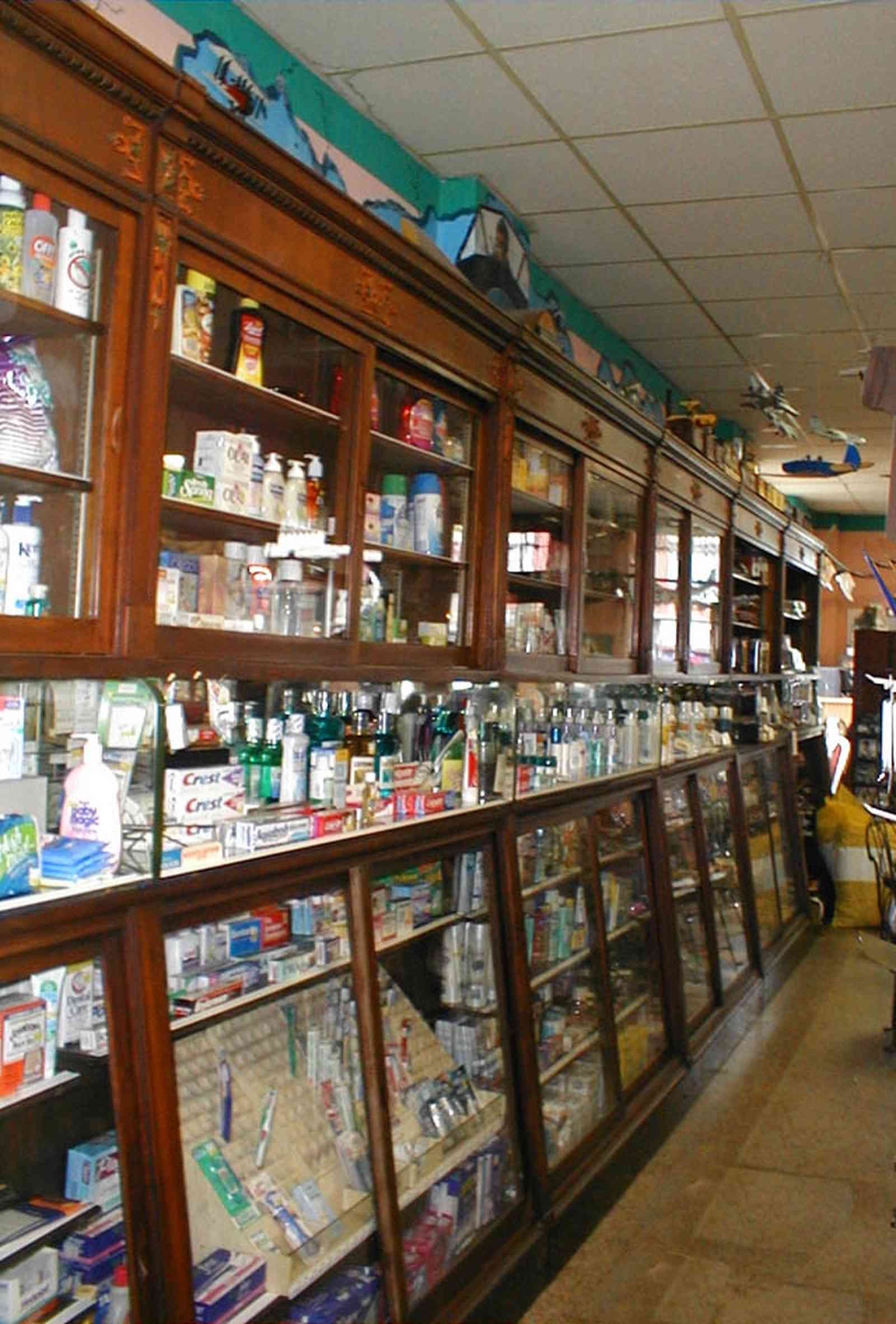 Foley:-Staceys-Drugstore_13.jpg:  drugstore, soda fountain, banana split, glass display cases, soda shop, awning, store front, brick building, art deco architecture, counter, cracker barrel, malts, milkshake, prescription drugs, druggist, card racks