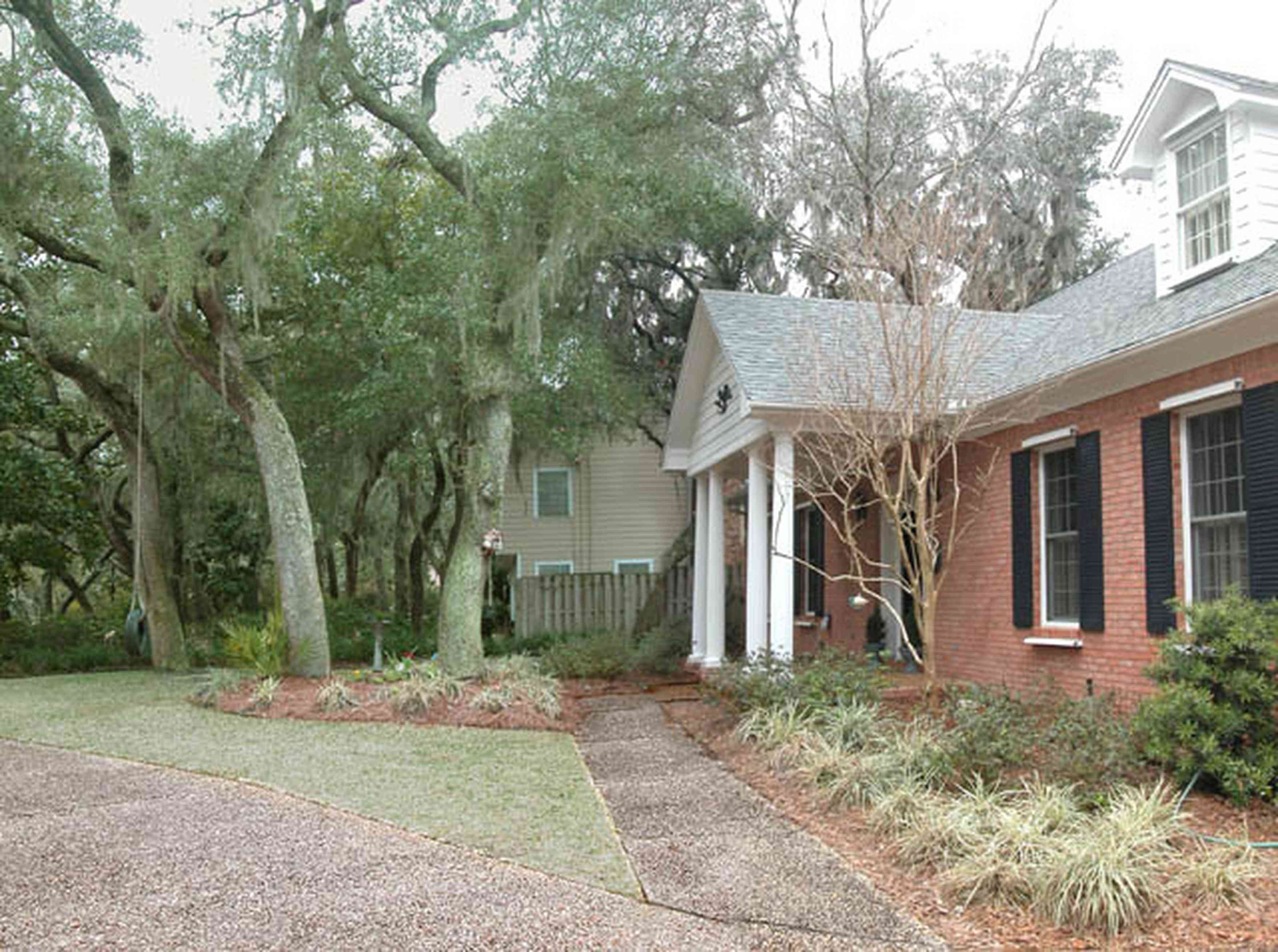 Gulf-Breeze:-228-North-Cliff-Dr_02.jpg:  colonial architectural style, columns, dormer window, shutters, oak trees, driveway, sidewalk, subdivision