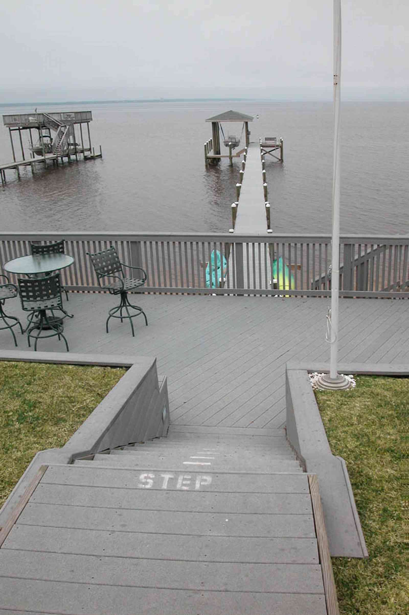 Gulf-Breeze:-228-North-Cliff-Dr_05.jpg:  swimming pool, bay, dock, pier, deck, flag pole, boat, bayfront