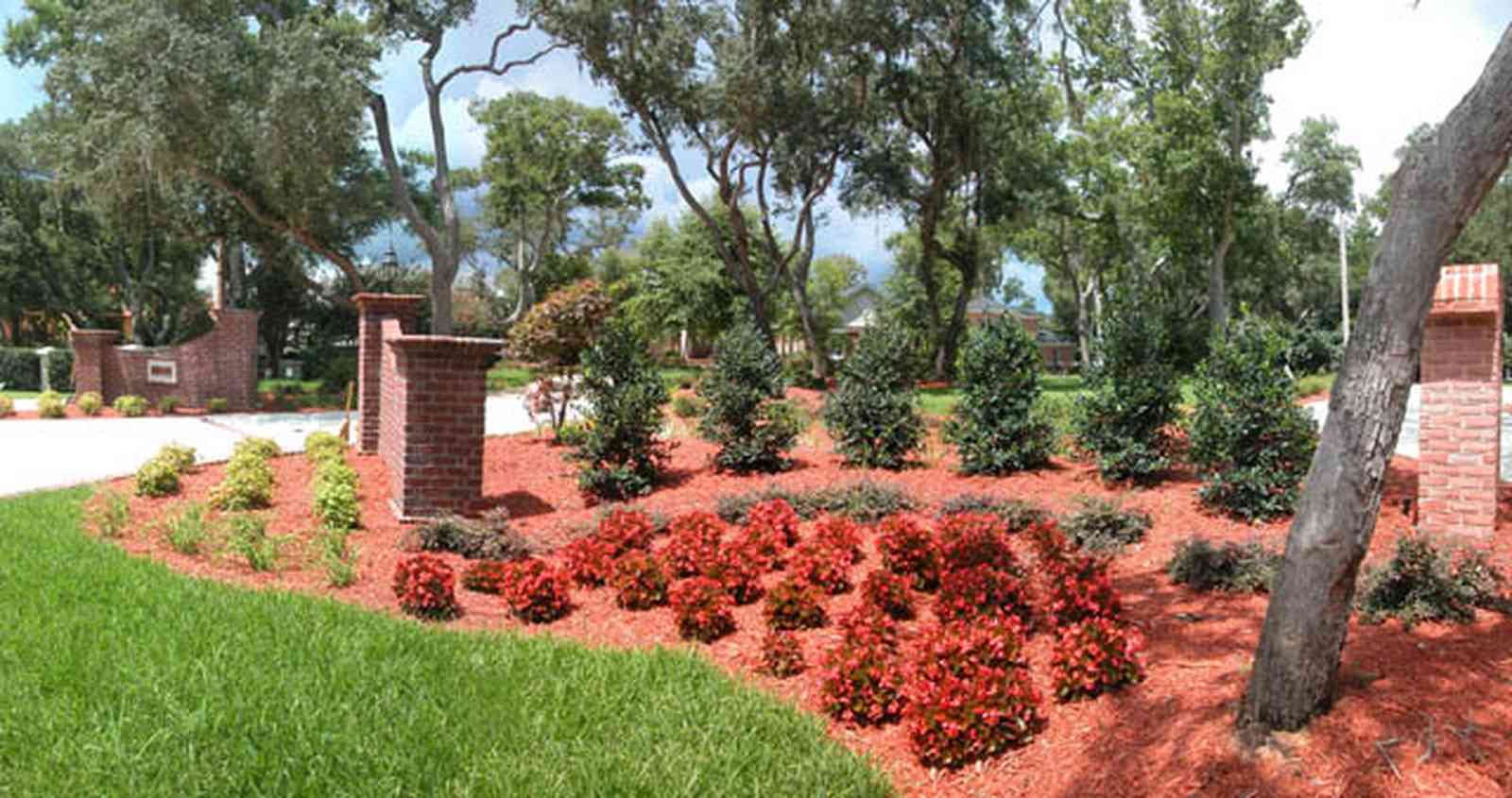 Gulf-Breeze:-706-Fair-Point-Drive_00a-copy.jpg:  gate, entrance, formal driveway, lanterns, oak trees, brick columns