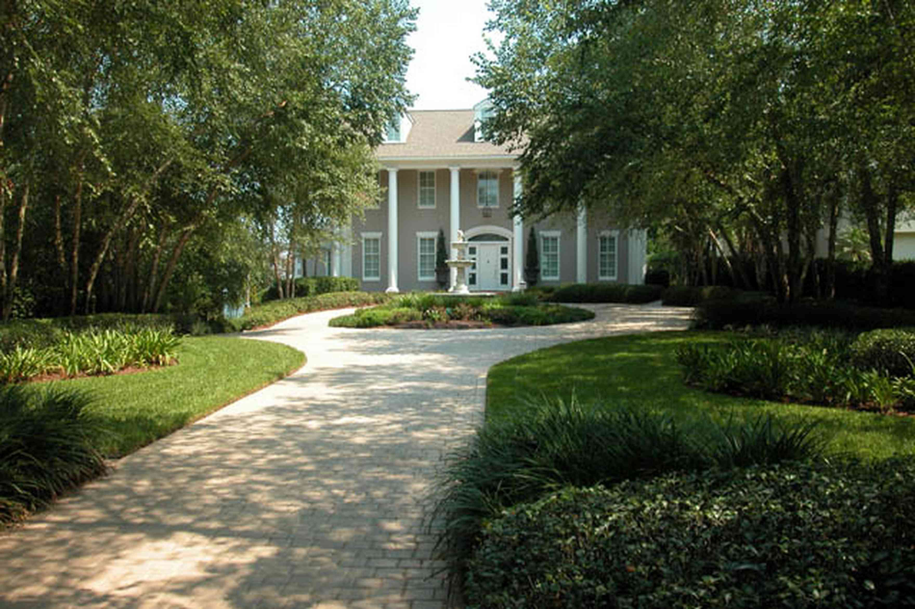 Gulf-Breeze:-72-Highpointe-Drive_01.jpg:  gas lantern, birch trees, circular driveway, fountain, tiled driveway
