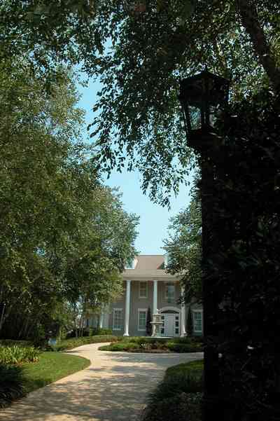 Gulf-Breeze:-72-Highpointe-Drive_02.jpg:  gas lantern, birch trees, circular driveway, fountain, tiled driveway