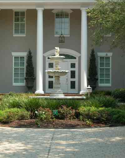 Gulf-Breeze:-72-Highpointe-Drive_03-copy.jpg:  gas lantern, birch trees, circular driveway, fountain, tiled driveway