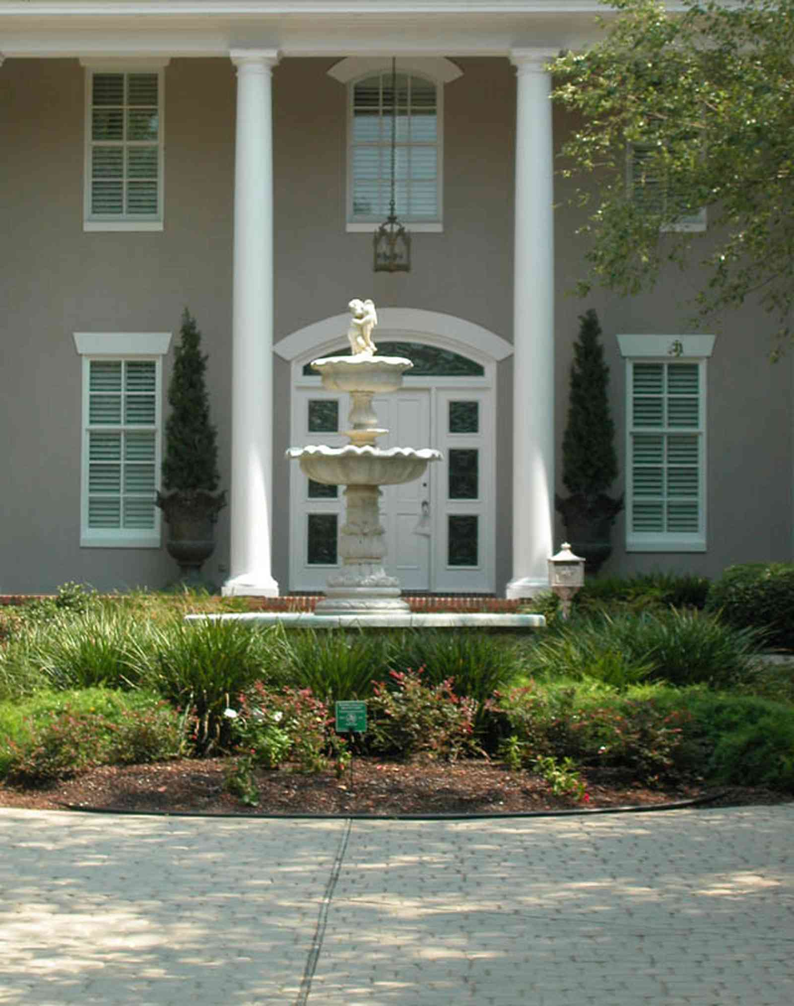 Gulf-Breeze:-72-Highpointe-Drive_03-copy.jpg:  gas lantern, birch trees, circular driveway, fountain, tiled driveway