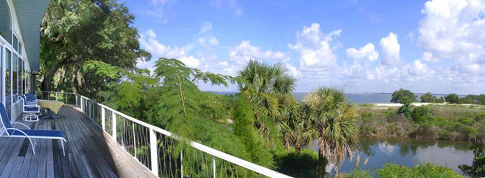 Gulf-Breeze:-Navy-Cove-House_03.jpg:  gulf coast, gulf breeze, dead mans island, deck, porch, mimosa tree, island, dunes, cumulus cloud