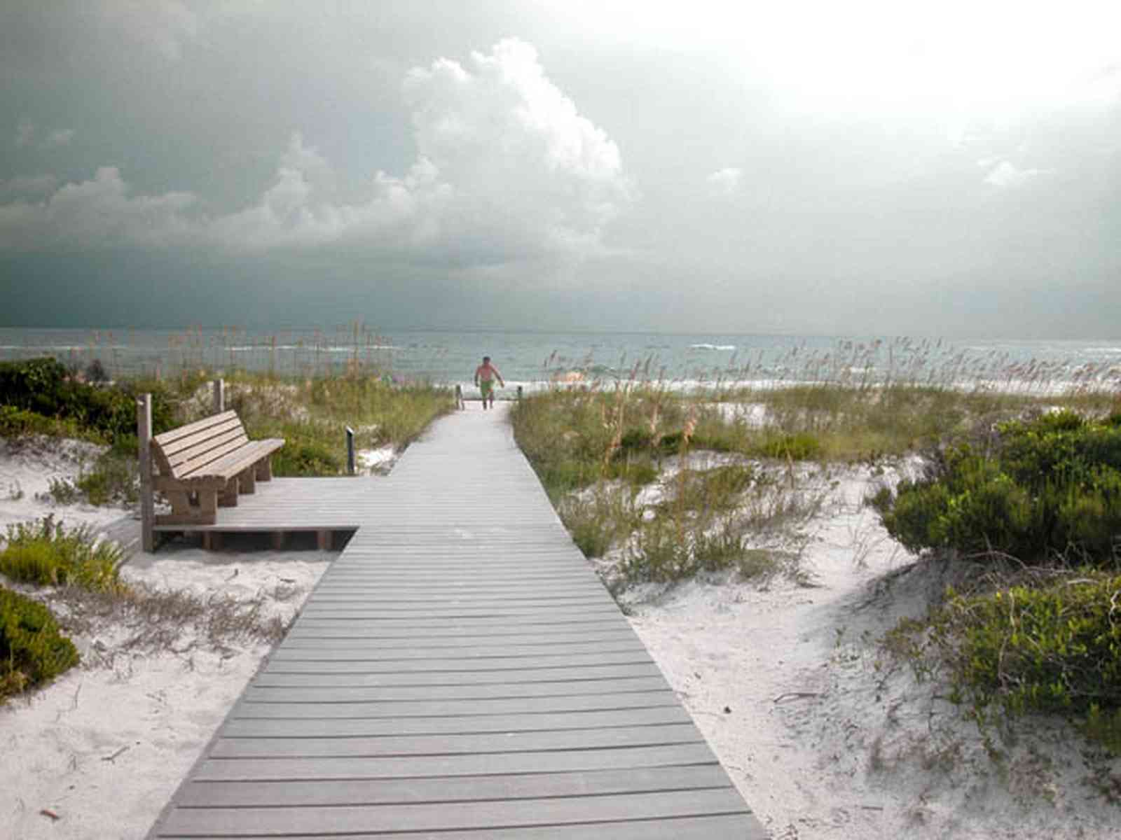 Gulf-Islands-National-Seashore:-Dunes-Nature-Trail_05.jpg:  bench, boardwalk, sea oats, barrier island, surf, waves, storm, cumulus clouds, barrier island
