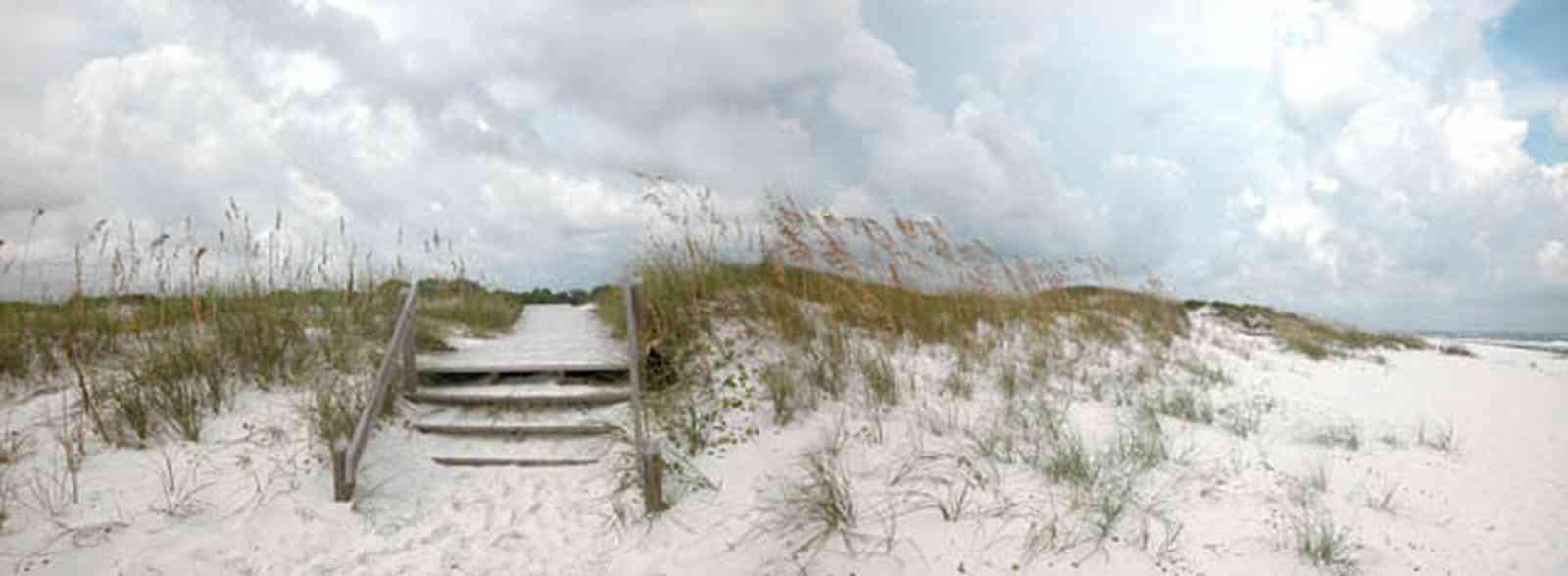 Gulf-Islands-National-Seashore:-Dunes-Nature-Trail_06.jpg:  bench, boardwalk, sea oats, barrier island, surf, waves, storm, cumulus clouds, barrier island